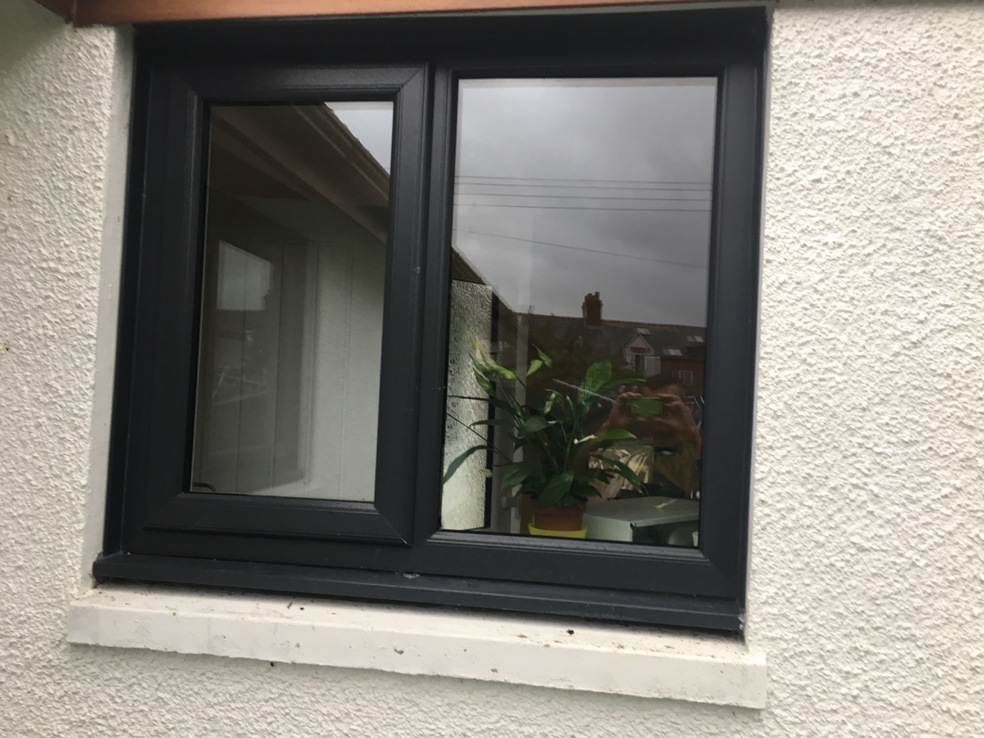 Dark window frame with an opening casement.